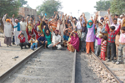 Residents of Mehna Basti staging a protest against the Railways in Bathinda