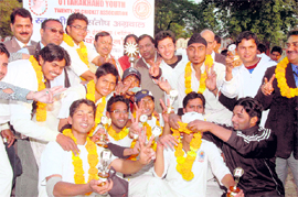 Graphic Era Institute-A team celebrate victory after receiving the Santosh Aggarwal Memorial Cricket Tournament trophy in Dehradun on Monday.