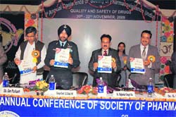 Group Capt GS Bedi of the Air Force Station, Sirsa, releases a souvenir during a conference on pharmacovigilance at the Rajendra Institute of Technology and Science, Sirsa.