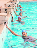 The swimmers practice in an open swimming pool in Ludhiana