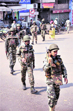 Paramilitary jawans conduct a flag march as part of the security arrangement ahead of the Jharkhand assembly elections, in Ranchi on Monday.