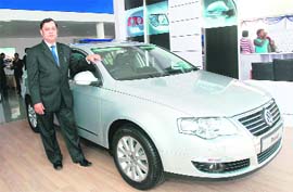 Neeraj Garg, Board member of Volkswagen Passenger Cars, poses with a Passat car at the inauguration of the companys first showroom in Haryana at Karnal on Tuesday