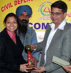 DC Rahul Tewari gives away prize to Bhavana Gupta, the winner of a declamation contest held at Guru Nanak Dev Khalsa Girls College in Bathinda on Tuesday