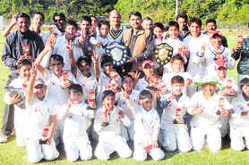 The team of Abhimanyu Cricket Academy pose with the trophy after winning the u-13 Cricket Tournament in Dehradun on Tuesday.
