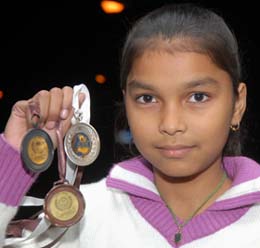 Chahat Sahota, winner of the state-level painting competition, shows her medals.