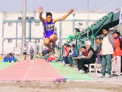 An athlete participates in the long-jump event on the second day of the Women Sports Festival in Ludhiana on Tuesday. 