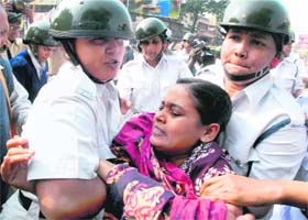 The police arrests activists of the Socialist Unity Centre of India during a 12-hour bandh in protest against price rise in Kolkata