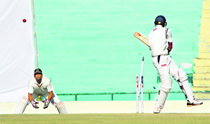 Love (unseen) cleans up Mehul Patel, as Punjabs wicketkeeper Chandan looks on at the PCA on Tuesday.