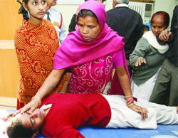 A woman looks after her child at a hospital in New Delhi