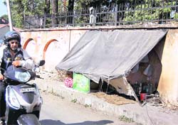 The makeshift home of a beggar in front of the Doon Hospital