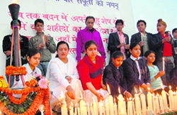 The mother of Gautam Gosain, who was killed in the Mumbai attacks, along with schoolchildren pay tributes to 26/11 victims at a function in Faridabad