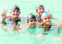 Jubilant Ludhiana girls after winning the 400X100 swimming medley relay in the Punjab State Womens Sports Festival in Ludhiana on Wednesday.