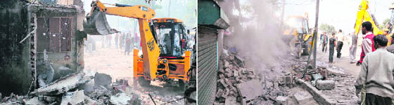 A JCB machine demolishes illegal structures on the Gill road in Ludhiana on Wednesday.