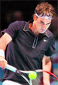 Roger Federer returns the ball to Andy Murray during their ATP World Tour Finals on Tuesday
