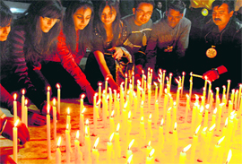 Residents light candles in the memory of Mumbai terror victims at Sukhna Lake in Chandigarh on Thursday.