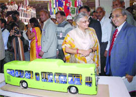 Delhi Chief Minister Sheila Dikshit looks at a low-floor bus model at the India International Trade Fair-2009 in New Delhi on Thursday.