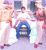 A liquor smuggler in the custody of the Kotwali police in Haridwar.