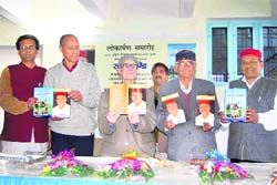 Vidya Sagar Nautiyal releases a book written by Garhwali singer Narender Negi in Dehradun on Wednesday. 