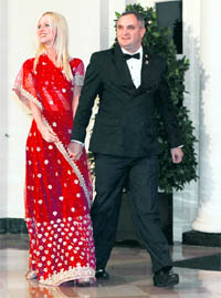 The Gatecrashers: Michaele and Tareq Salahi arrive at a state dinner hosted by President Barack Obama for Prime Minister Manmohan Singh at the White House in Washington on Tuesday. The Virginia couple has left the secret service baffled as it managed to slip into Tuesday nights party even though they were not on the guest list
