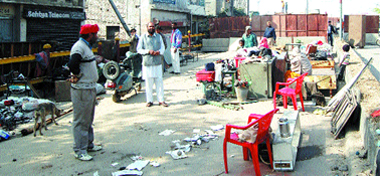 The occupants who were evicted from the old Sabji Mandi by the Municipal Corporation with their belongings placed in the open in Amritsar 