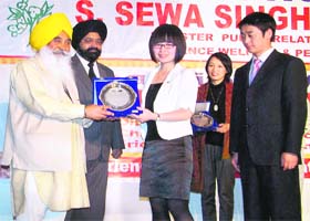 Minister for information and public relations Sewa Singh Sekhwan presents a memento to a member of a Chinese delegation during a function at Mohali