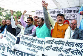 BJP leaders and supporters shout slogans during a dharna to protest the revoking of the lottery bill in Parliament, at Jantar Mantar in New Delhi on Friday. 