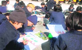 Students participate in a drawing competition at Shiv Dale School
