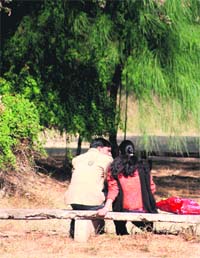 COZY MOMENTS: A couple enjoys the warmth of sun on the Jammu University campus