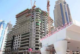 A flyover stands unfinished next to a construction site in Dubai's Marina area
