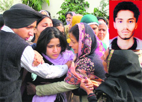 Relatives console the sister of Arshdeep (inset) in Mohali on Saturday.