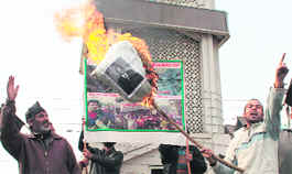 SRTC employees burn an effigy of Finance Minister Abdul Rahim Rather during a protest at Lal Chowk in Srinagar on Saturday.