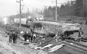 Investigators and rescue workers are seen amid wreckage and damaged coaches at the site of a train derailment near the town of Uglovka, some 400 km north-east of Moscow