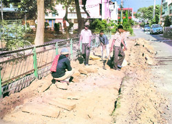 Workers of a contractor remove old footpaths to replace with the new ones in Phase II, Mohali.