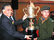 The Mizoram Governor, Lieut-Gen MM Lakhera (retd), presents a trophy to a cadet of Rashtriya Indian Military 
