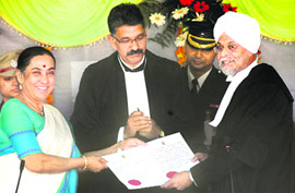 Uttarakhand Governor Margaret Alva presents the letter of appointment to Justice JS Khehar after his swearing-in as the Chief Justice of the Uttarakhand High Court in Dehradun on Sunday.