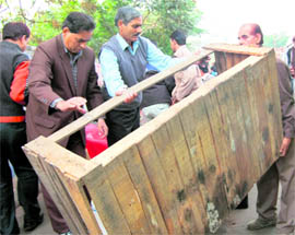 Employees of the Jammu Municipal Corporation remove encroachments in Jammus Maheshpura Chowk on Sunday