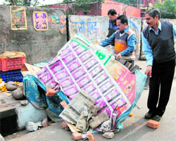 Employees of the Jammu Municipal Corporation remove encroachments in Jammus Maheshpura Chowk on Sunday
