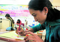 Students participate in a painting competition at University of Jammu in Jammu on Sunday. 