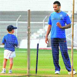Zaheer Khan speaks to coach Gary Kirstens son Joshua at a practice session in Mumbai on Sunday evening.