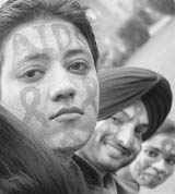 Students raise awareness on AIDS by painting their faces on the eve of World AIDS Day in Patiala on Monday.