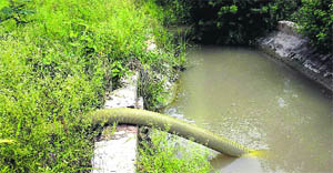 A pipe is being used to draw water illegally from a canal in a Jhajjar village.