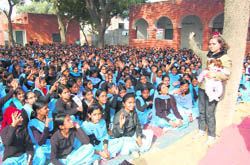 Ishita Uppal, states brand ambassador against female foeticide, with schoolgirls in Fatehabad.