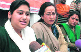 Anchal Sharma, aka Amina Yousuf, flanked by Mahila Sanrakshan Samiti members, talks to reporters in Jammu on Monday.