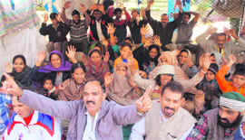 Shiv Sena (United) and Bajrang Dal activists protest against the encroachment drive against shanties outside the divisional commissioners office in Jammu on Monday. A Tribune photograph