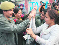 Striking State Road Transport Corporation employees scuffle with police personnel during a protest march in Jammu on Monday. 