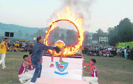 An Army school student jumps through a ring of fire at a function in Sujanpur.