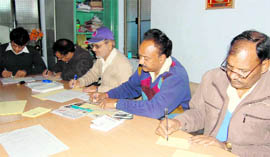 Members of the Diploma Engineers Maha Sangh write postcards, detailing their grievances, to the CM in Dehradun on Wednesday. Tribune photo: Anil P Rawat