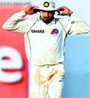 Indian cricketer Harbhajan Singh walks back after the first days play in Mumbai on Wednesday