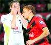 Tottenham Hotspur's Peter Crouch (L) reacts after missing a chance to score as Manchester Uniteds Wes Brown runs past during their English League Cup quarter-final soccer match on Tuesday. United won 2-0