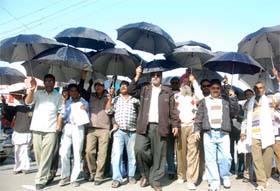 FLY ASH MENACE: Residents carry umbrellas to stage a symbolic protest in Bathinda
